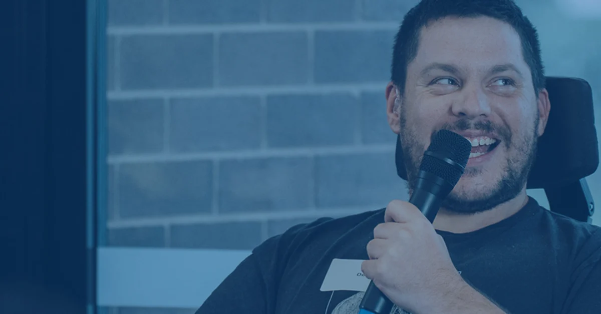 Declan Lee talks into Microphone at Building Bridges Nework